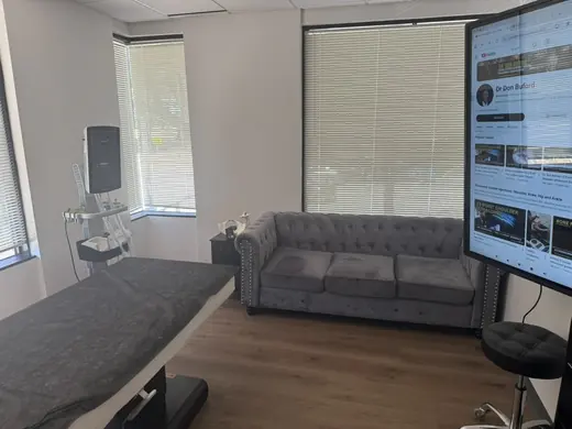 Exam room with musculoskeletal ultrasound machine and treatment table