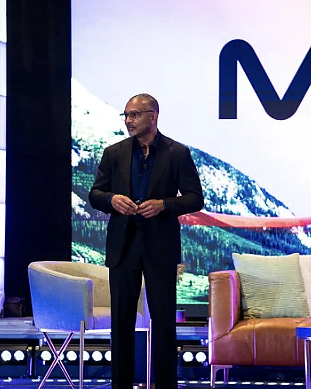 Don Buford, M.D. delivering a keynote on stage at an orthobiologics conference